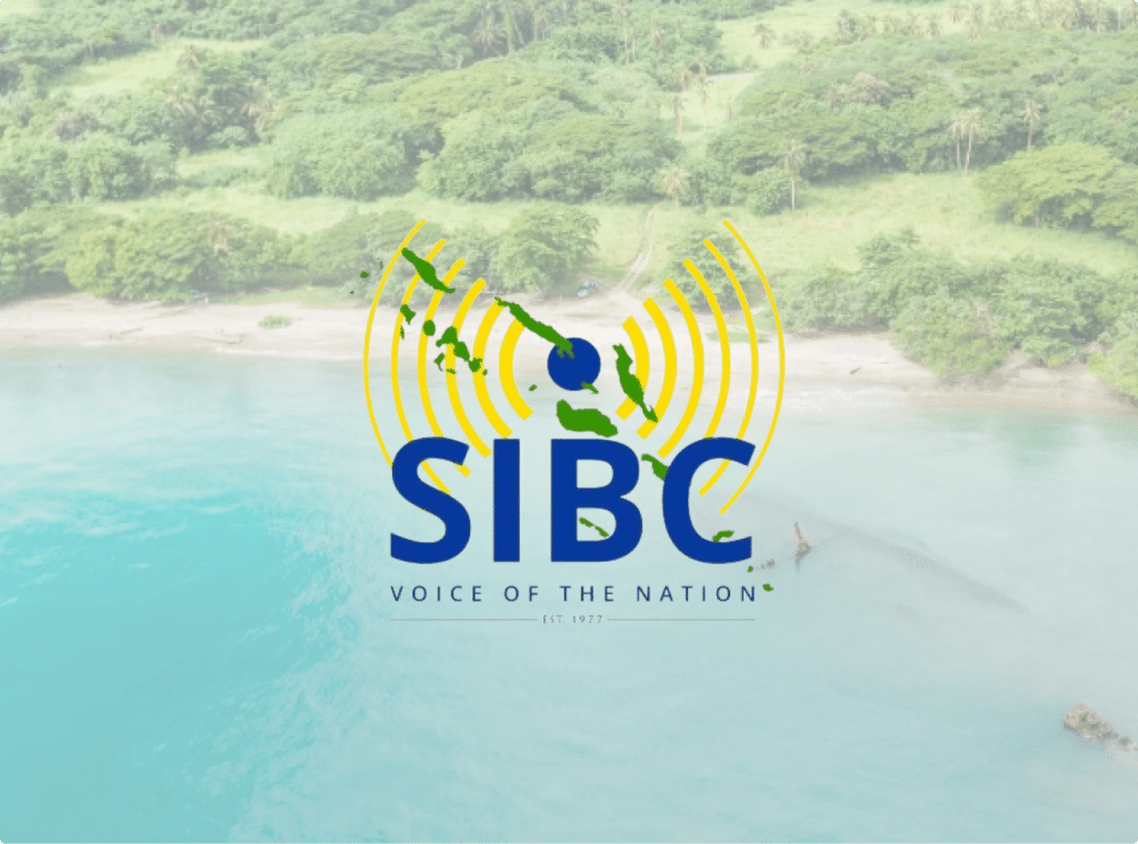 A beach in Guadalcanal Province of the Solomon Islands, with the Solomon Islands Broadcasting Corporation logo overlaid in the center of the image.